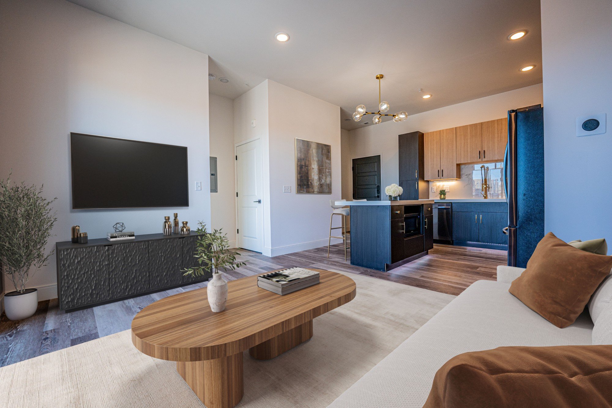 A modern living room with a wooden coffee table and a flat screen TV.