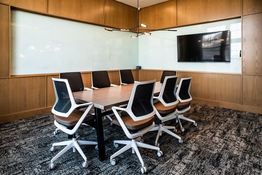 a small conference room with a table and chairs