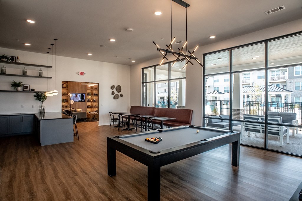 a pool table in the clubhouse at the bradley braddock road station apartments
