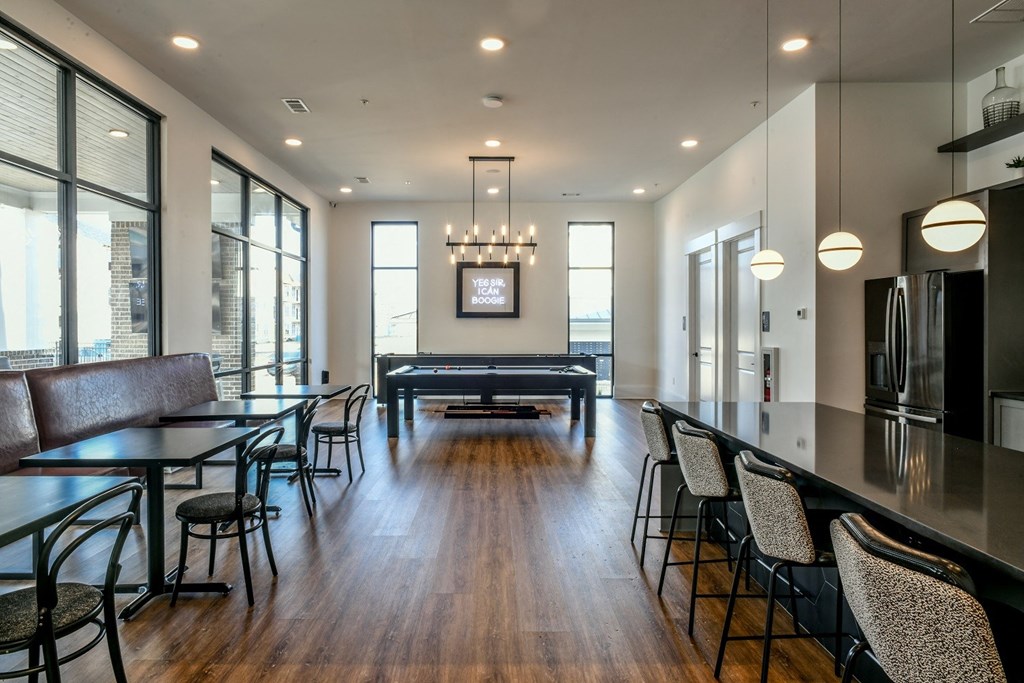 a room with a pool table and a bar