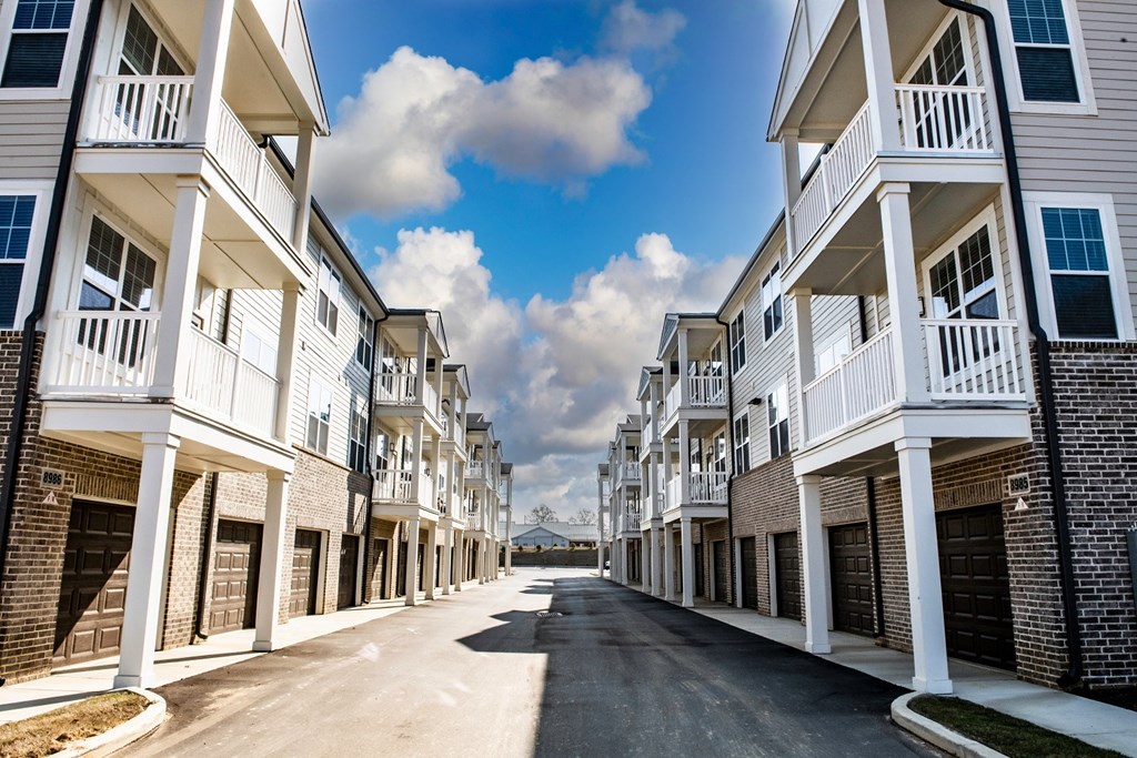 a street with rows of apartment buildings on each side
