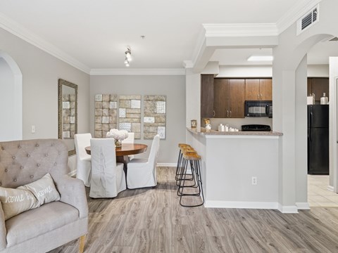 A modern kitchen with a dining table and chairs.