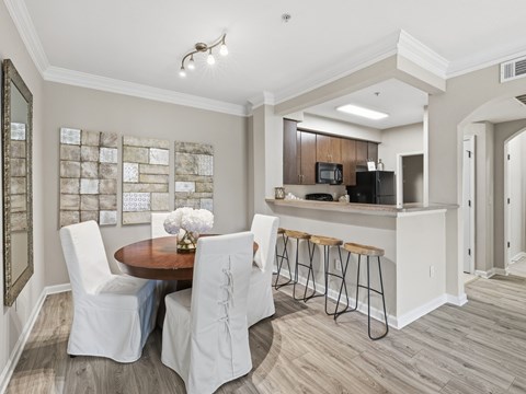 A modern kitchen with a dining table and chairs.