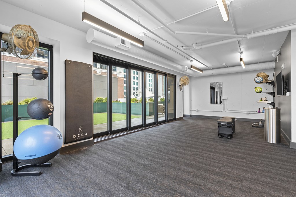 a workout room with a yoga ball and other exercise equipment in front of a window at Deca Apartments, Greenville, South Carolina