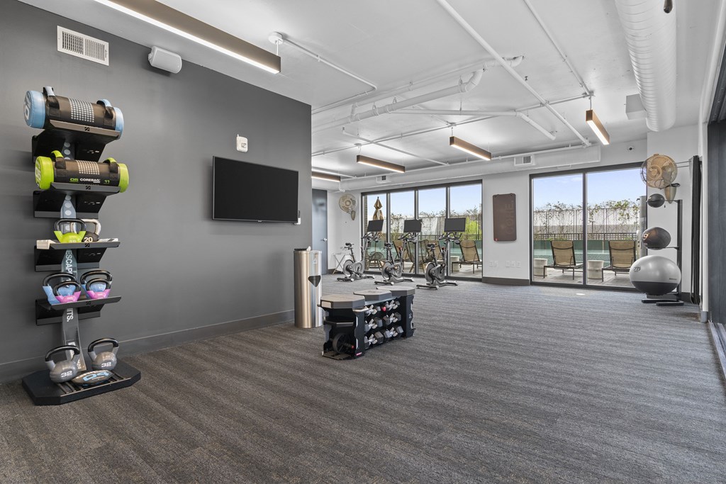 room with gym equipment and a television at the district flats apartments at Deca Apartments, Greenville, South Carolina
