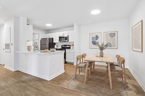 A kitchen with a table and chairs in the middle of the room.