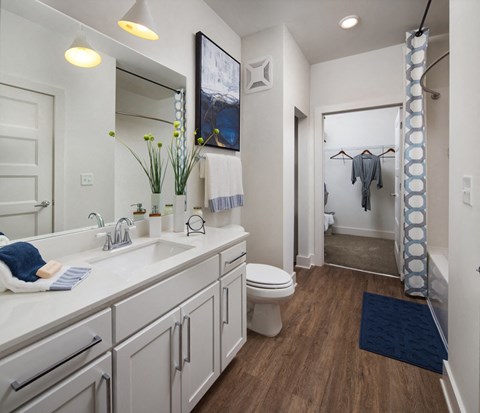 Relax in your Stunning Bathroom with Double Vanity Sinks, Subway Tile Showers with Glass Enclosures and Full Length Mirrors at Echo at North Pointe Center Apartment Homes, Alpharetta, GA 30009