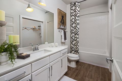 Relax in your Stunning Bathroom with Double Vanity Sinks, Subway Tile Showers with Glass Enclosures and Full Length Mirrors at Echo at North Pointe Center Apartment Homes, Alpharetta, GA 30009