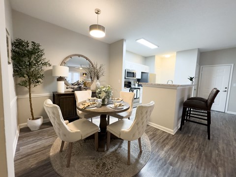 A dining room with a round table and chairs at Enclave at Wolfchase Apartments, Memphis