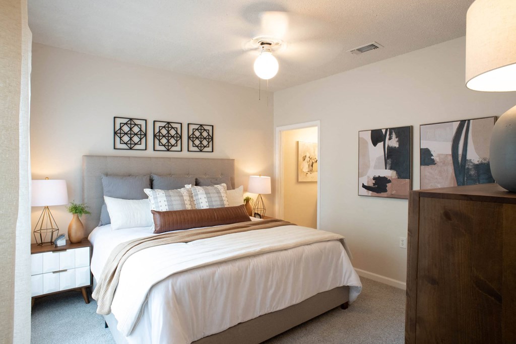 a bedroom with a large bed and a dresser at Appling Lakes, Cordova