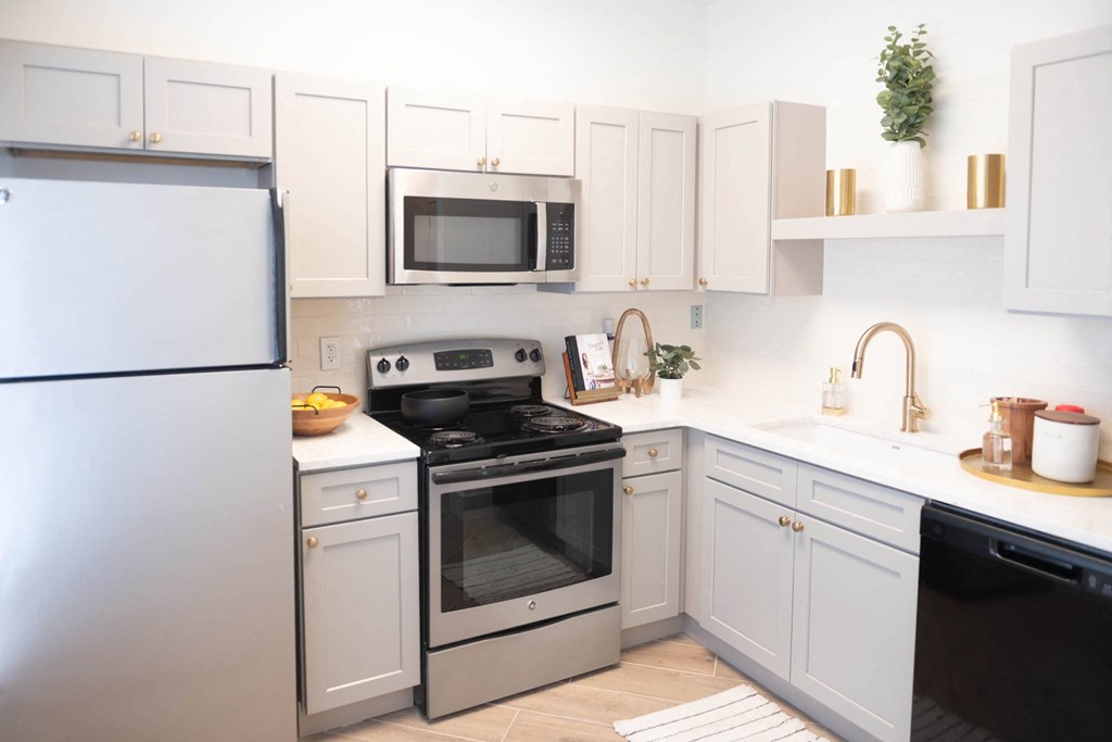 a kitchen with white cabinets and stainless steel appliances at Appling Lakes, Cordova, TN, 38016