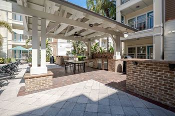 A patio with a table and chairs under a roof at Park Place Oviedo Apartments, Oviedo, FL