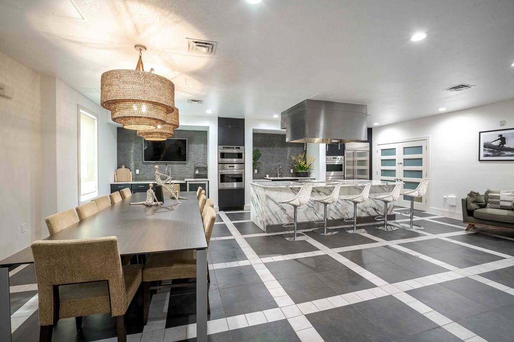 A modern dining room with a large table and chairs. A modern dining room with a large table and chairs at Park Place Oviedo Apartments, Oviedo, Florida