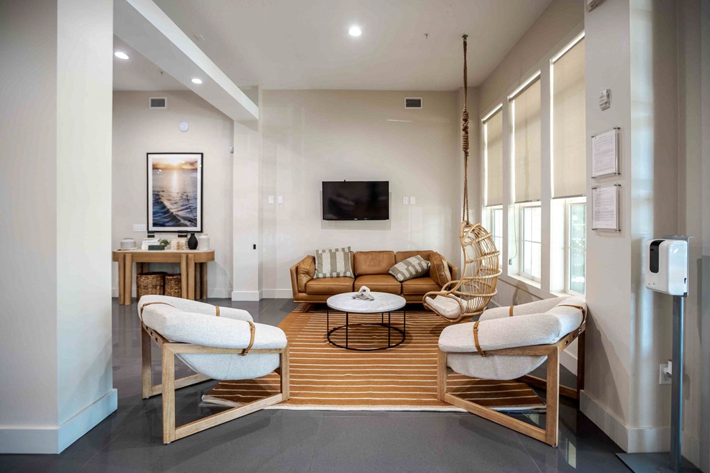 A modern living room with a white sofa and a wooden coffee table at Park Place Oviedo Apartments, Oviedo, FL, 32765