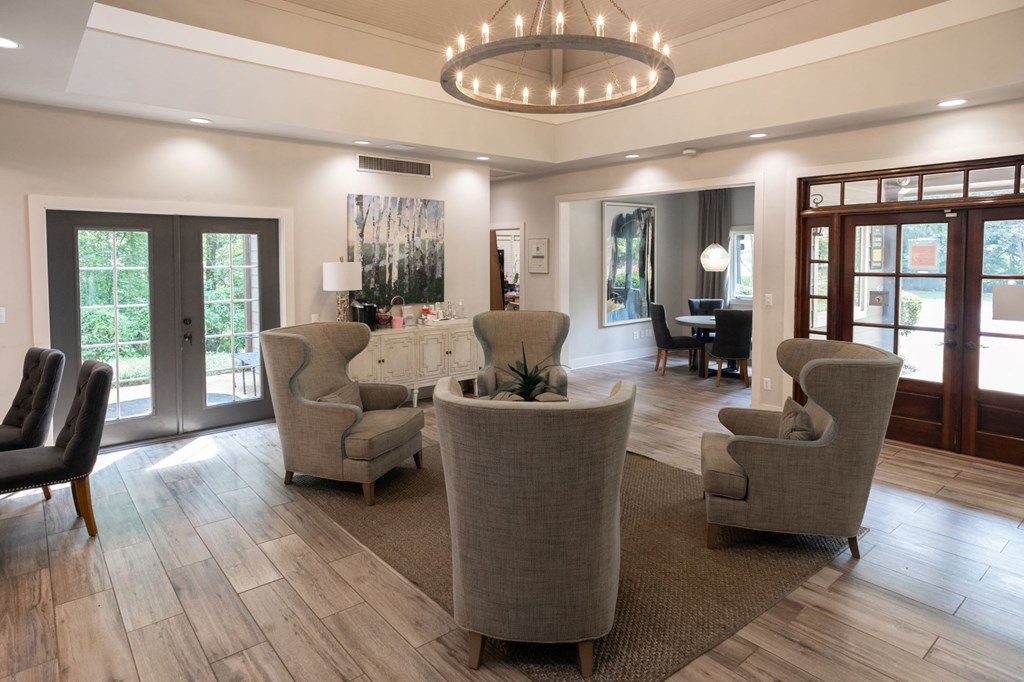 a living room with couches and chairs and a chandelier