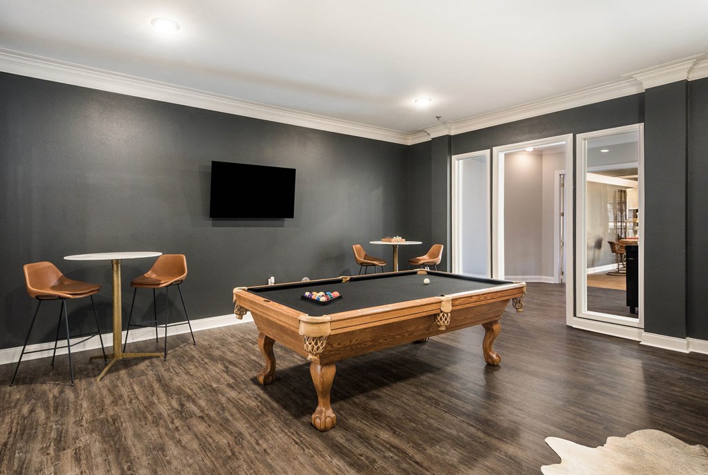 a games room with a pool table and a tv at Arlo Luxury homes Apartments, Little Rock, Arkansas