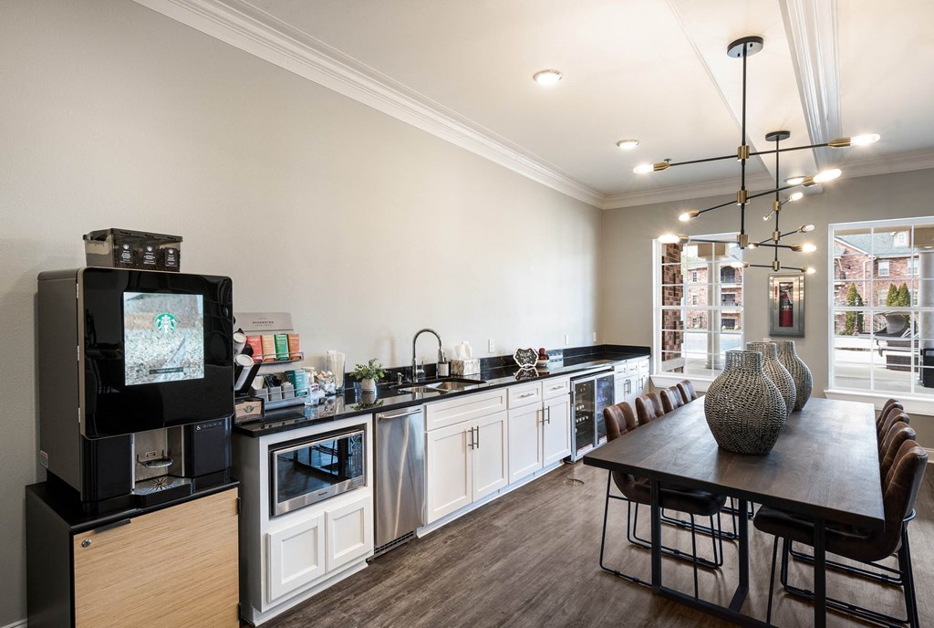 a kitchen and dining room with a table and a television at Arlo Luxury homes Apartments, Little Rock, AR