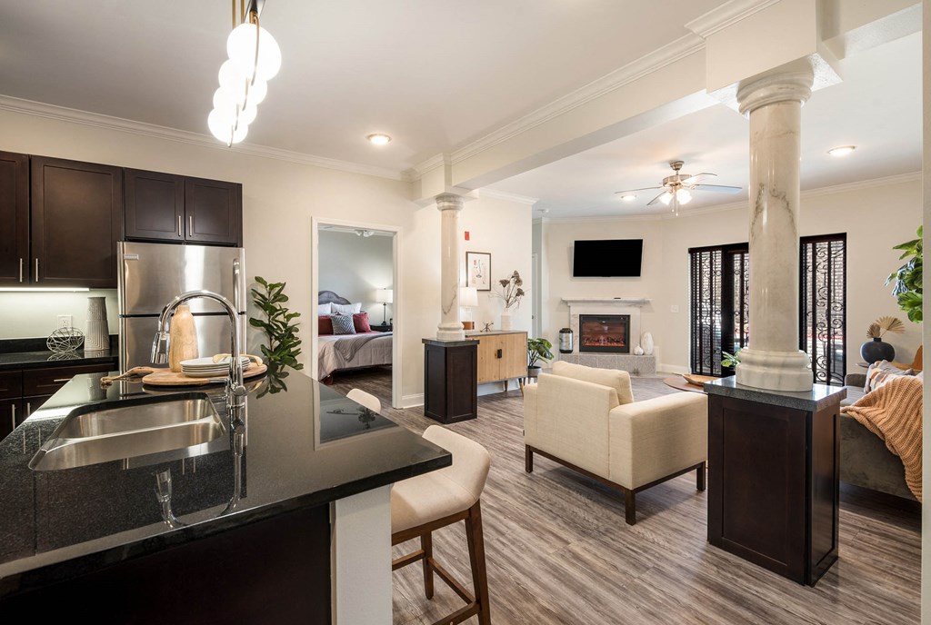 a kitchen and living room with a couch and a table at Arlo Luxury homes Apartments, Arkansas