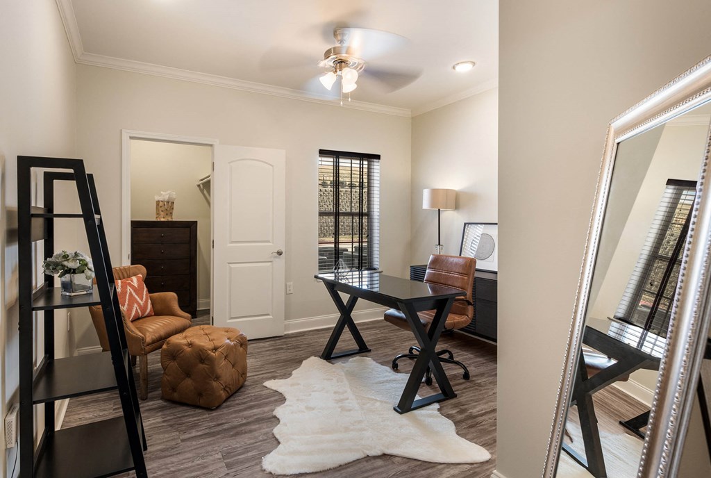 a living room with a desk and a mirror at Arlo Luxury homes Apartments, Little Rock, AR