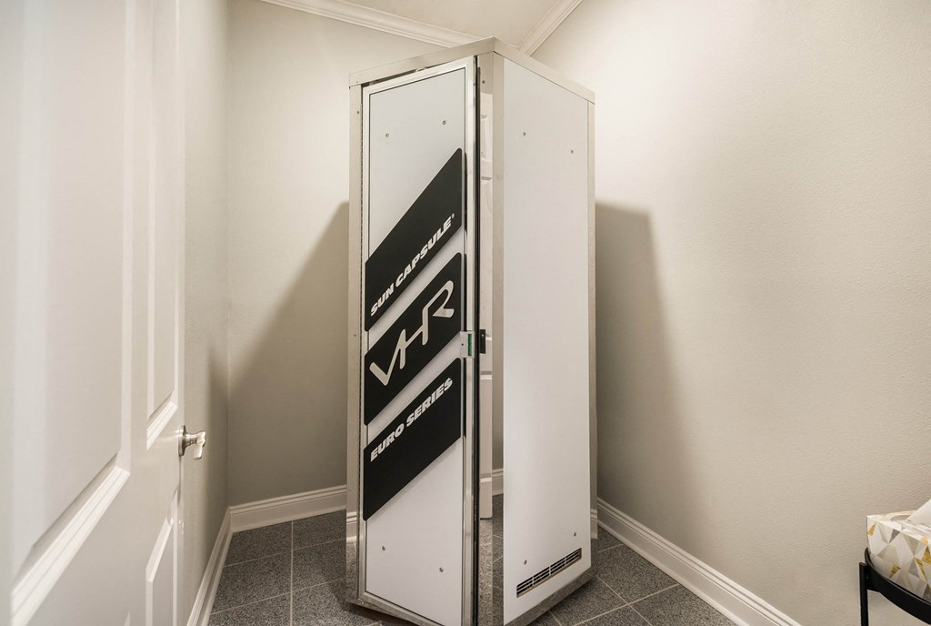 a small refrigerator in a small room in a room with white walls  at Arlo Luxury homes Apartments, Little Rock