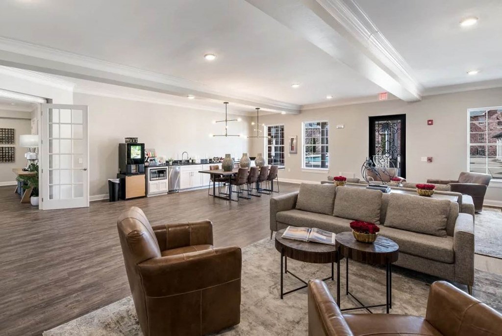 a living room with couches and chairs and a kitchen  at Arlo Luxury homes Apartments, Little Rock, Arkansas