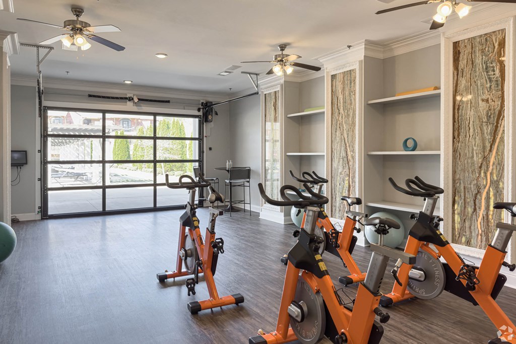 an indoor cardio room with exercise bikes and a window at Arlo Luxury homes Apartments, Little Rock, AR,72210