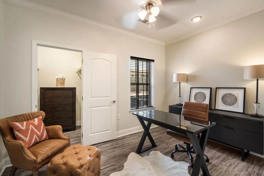 a living room with a desk and a chair  at Arlo Luxury homes Apartments, Little Rock, AR,72210