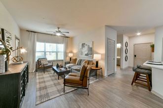 Gorgeous Modern Living Room with Two Tone Paint Colors and Wood Plank Vinyl Flooring (in Select Units) at Ashby at Ross Bridge, Hoover, AL 35226