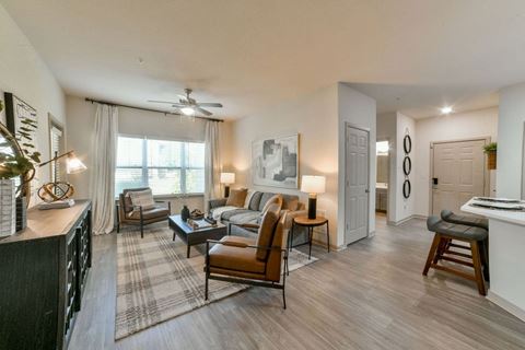 Gorgeous Modern Living Room with Two Tone Paint Colors and Wood Plank Vinyl Flooring (in Select Units) at Ashby at Ross Bridge, Hoover, AL 35226