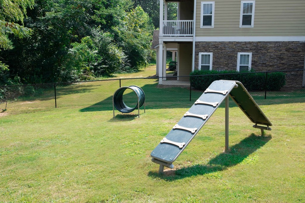 a seesaw in a yard with a house in the background at Ashby at Ross Bridge, Hoover