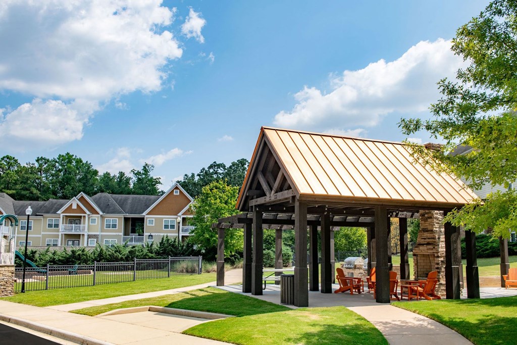 a pavilion with a lawn and trees in the background at Ashby at Ross Bridge, Hoover, AL