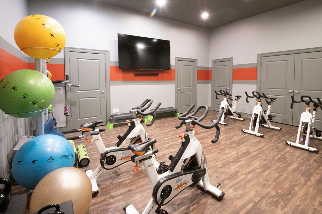 A gym with exercise equipment and exercise balls. at Cambridge Square, Overland Park, KS