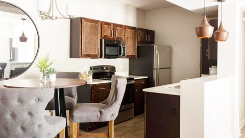 a kitchen and dining room with a table and chairs a kitchen and dining room with a table and chairs at Esplanade District Apartments, Arkansas