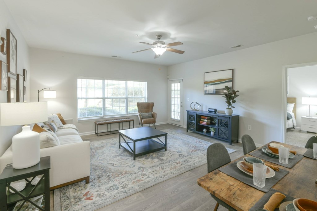 A dining room with a wooden table set for a meal.