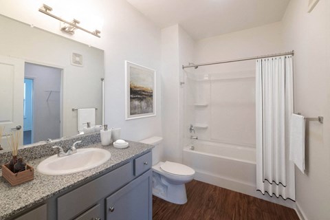 A bathroom with a white sink, toilet, and bathtub. at Lakeland Town Square, Lakeland, Tennessee