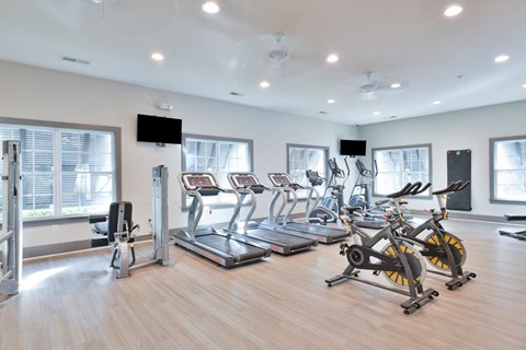a gym with cardio equipment and windows at Legends at Chatham, Savannah, GA
