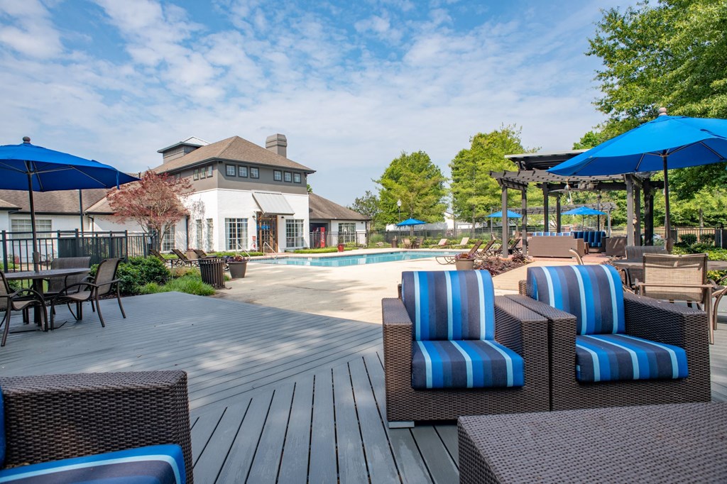 a swimming pool with lounge chairs and umbrellas at Lincoln at Wolfchase, Tennessee, 38016
