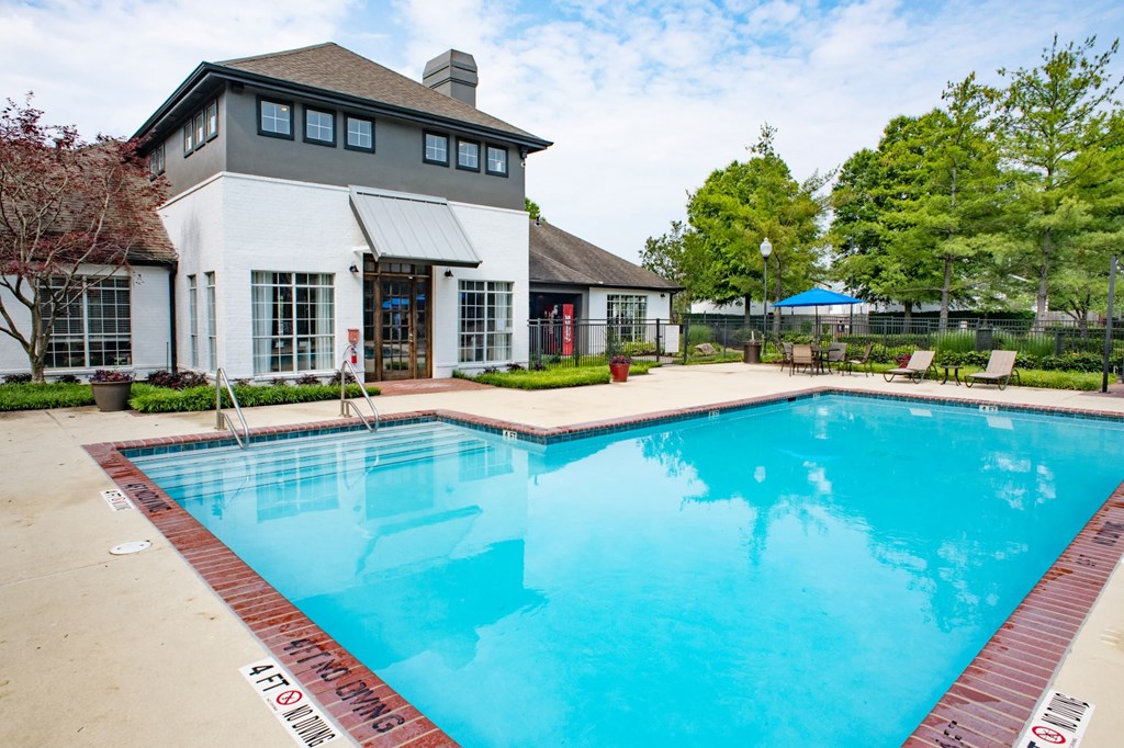 a swimming pool with a white building in the background at Lincoln at Wolfchase, Tennessee