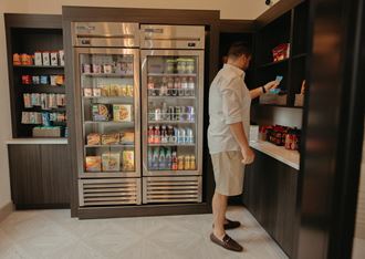 a man standing in front of a refrigerator at Livano Grand National, Orlando Florida