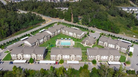 A large apartment complex with a swimming pool in the middle.