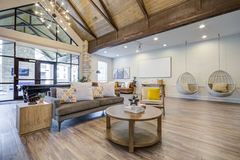 A modern living room with a wooden floor and a glass ceiling.