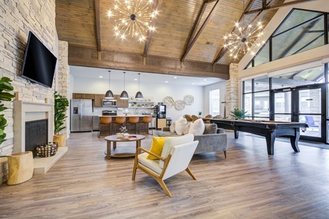 A living room with a fireplace and a television on the wall.