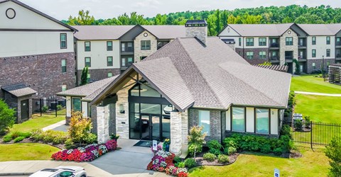 an aerial view of a house with an apartment building in the background at The McKenzie Park Apartments, Arkansas, 72223