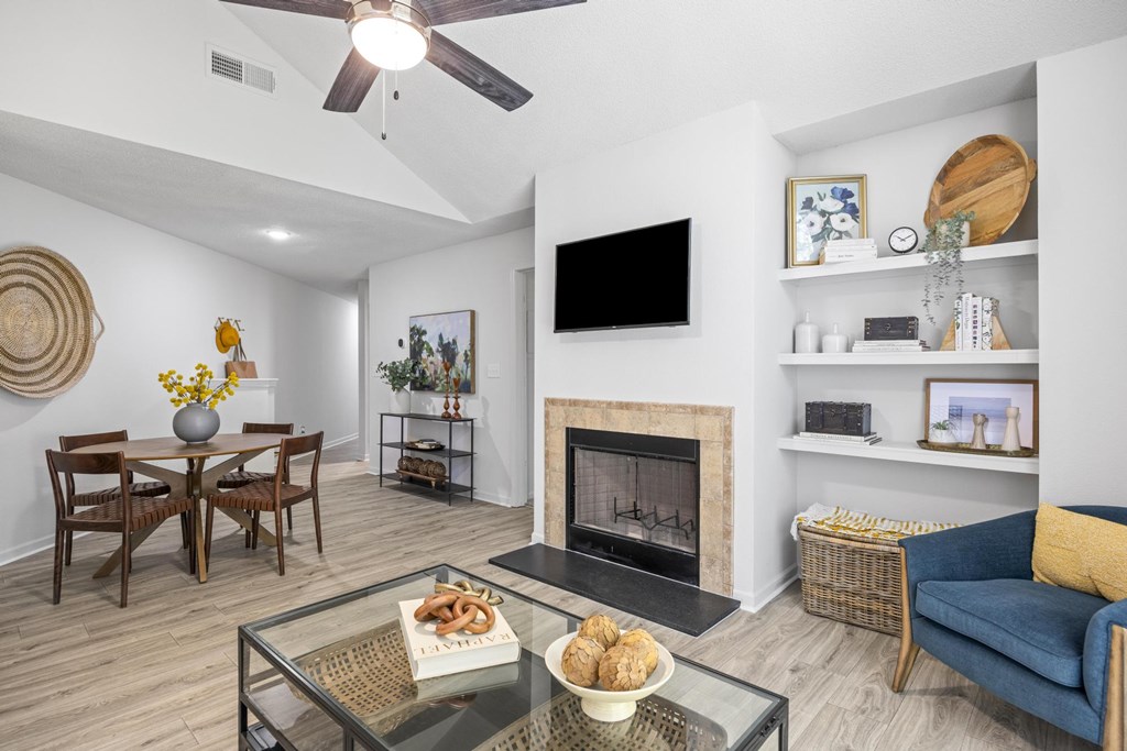 A living room with a fireplace and a flat screen TV at Pointe Royal, Kansas, 66213