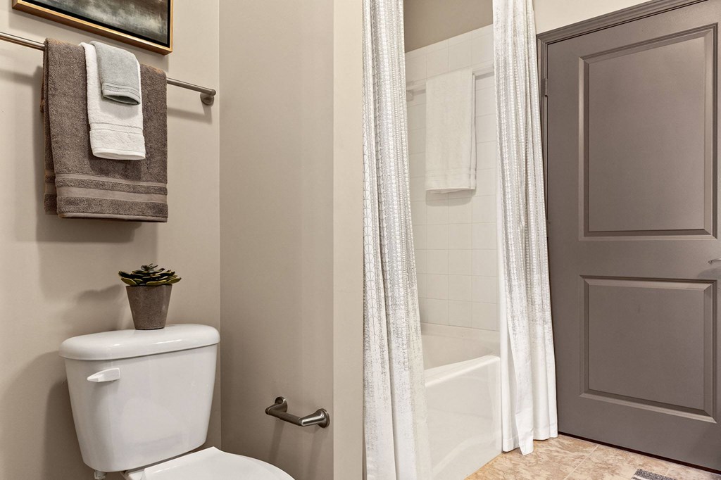a bathroom with a toilet and a shower and a towel rack at The Ridge at Chenal Valley, Arkansas
