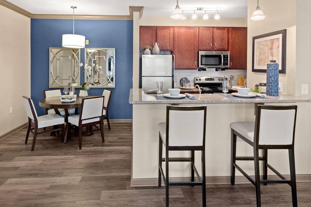 a kitchen with a bar and a dining room table at The Ridge at Chenal Valley, Little Rock, 72223