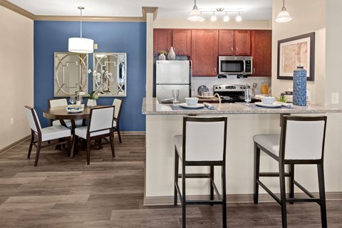 a kitchen and dining area with a table and chairs