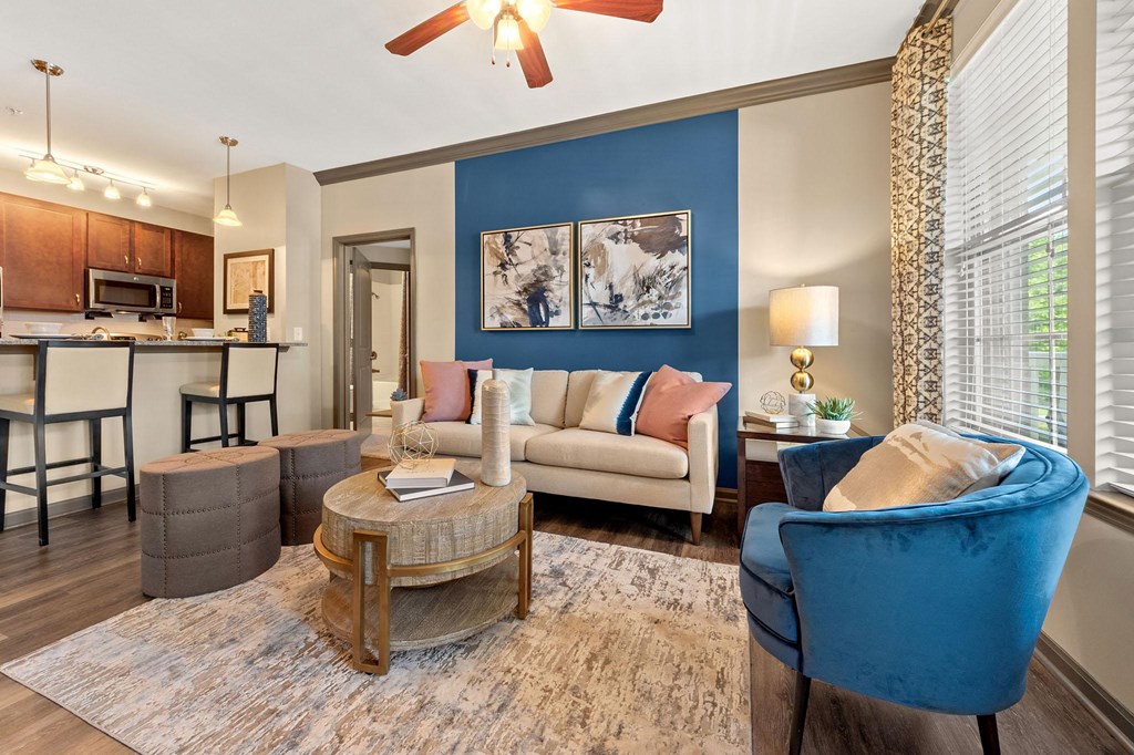 a living room with blue chairs and a geometric wallpaper at The Ridge at Chenal Valley, Arkansas