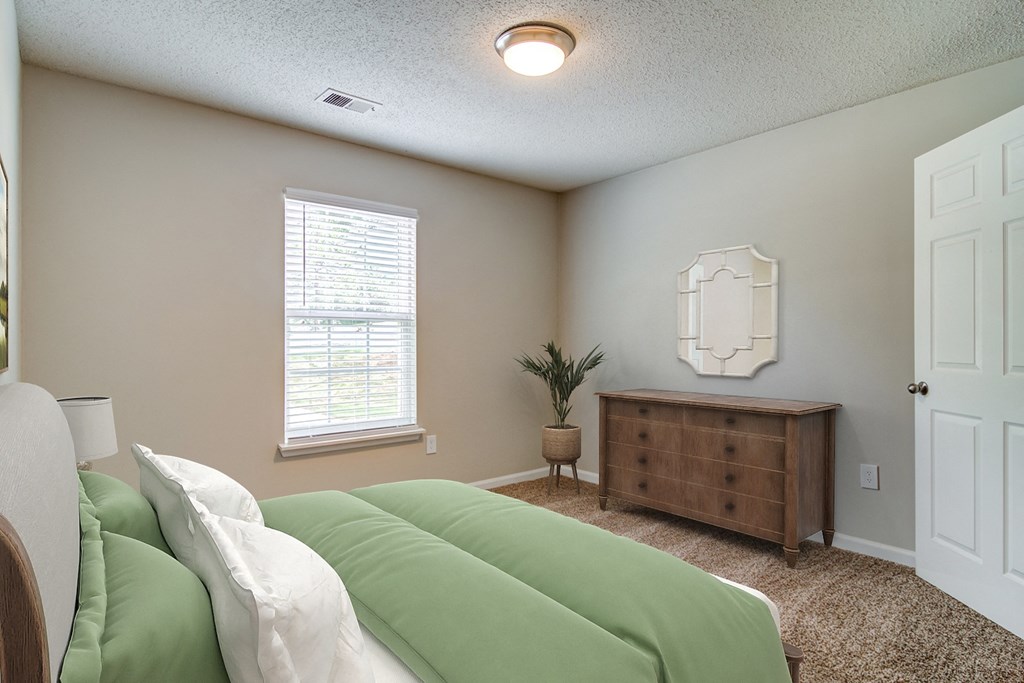 a bedroom with a bed and a dresser and a window
