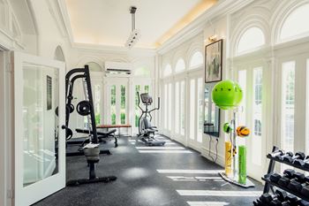A gym with a variety of equipment including a treadmill, weights and a bench.at Parkview Apartments, Memphis Tennessee